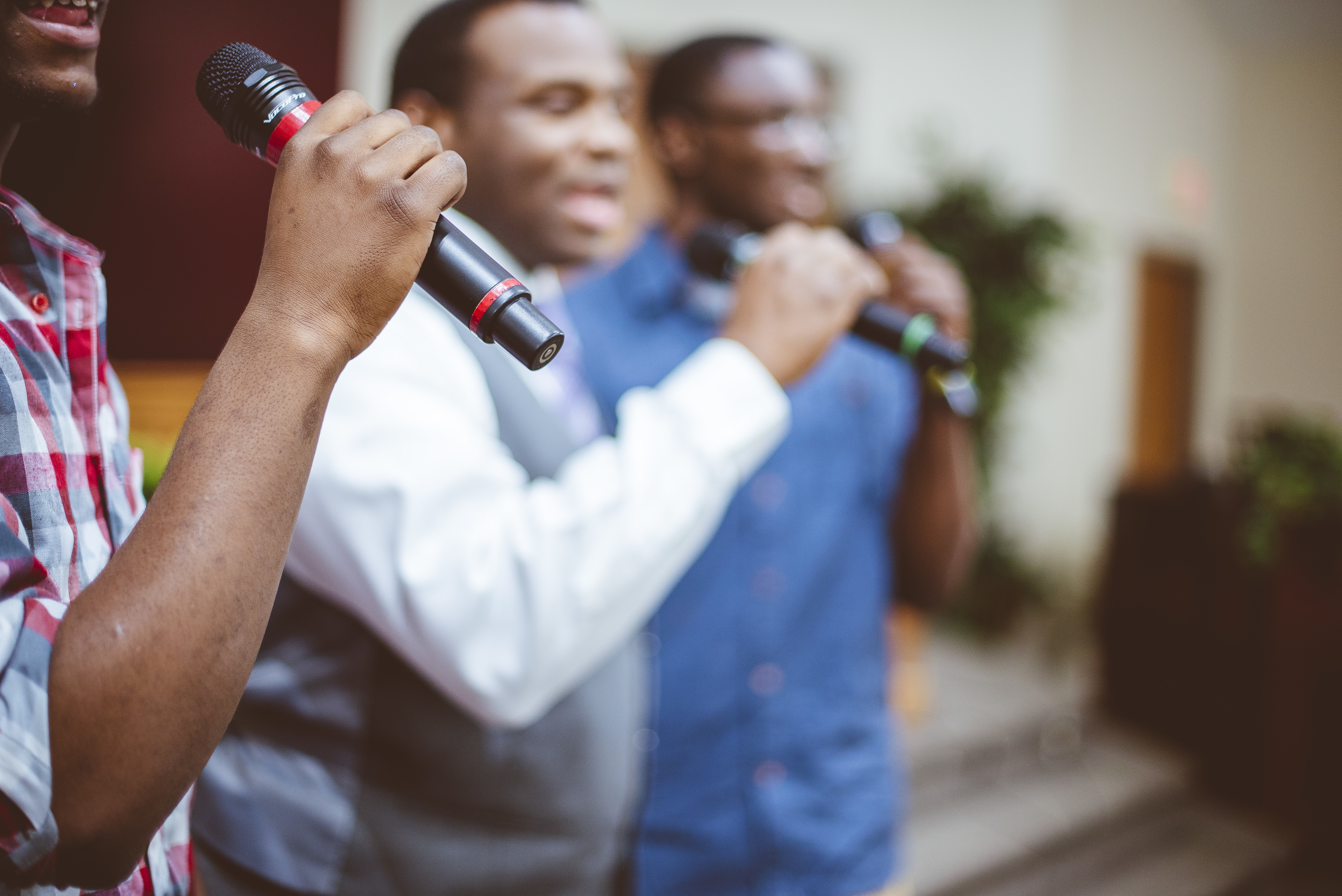 group-of-african-american-friends-singing-with-mic-2022-12-18-20-46-15-utc