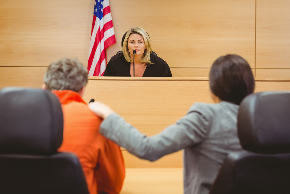 Judge and lawyer discussing the sentence for prisoner in the court room