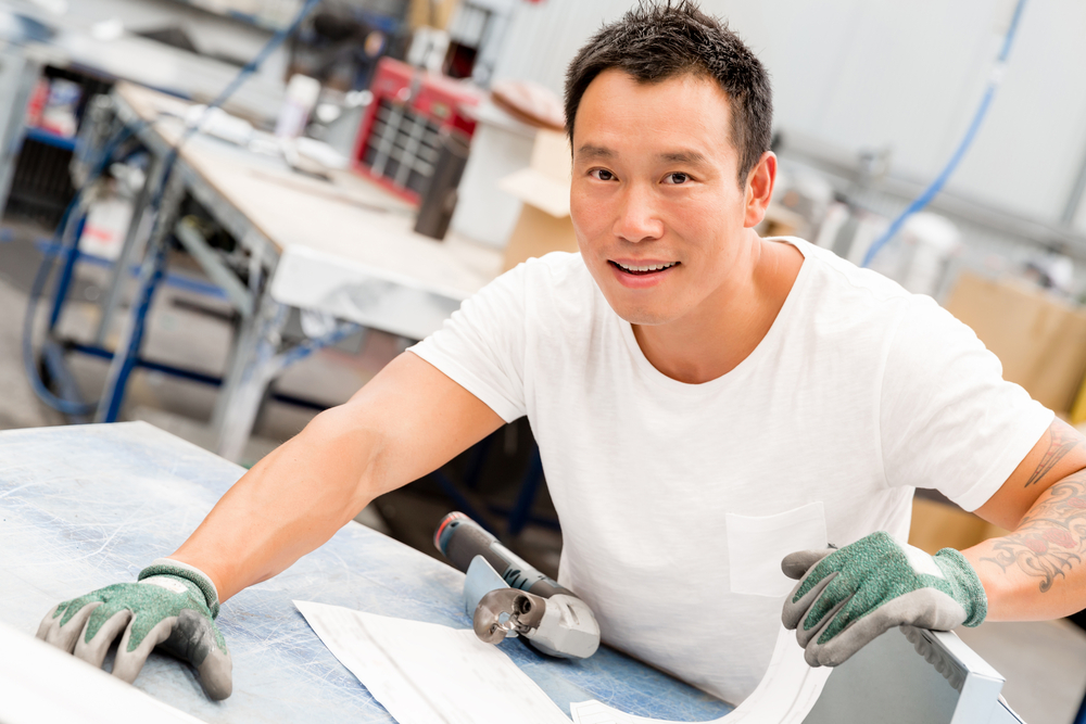 portrait of asian worker in production plant working on the factory floor